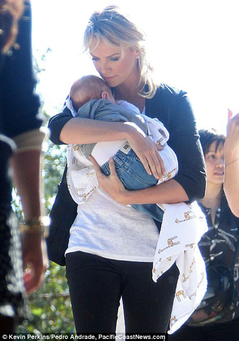 Charlize Theron holding baby