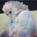 Kanye West feathered mask on stage